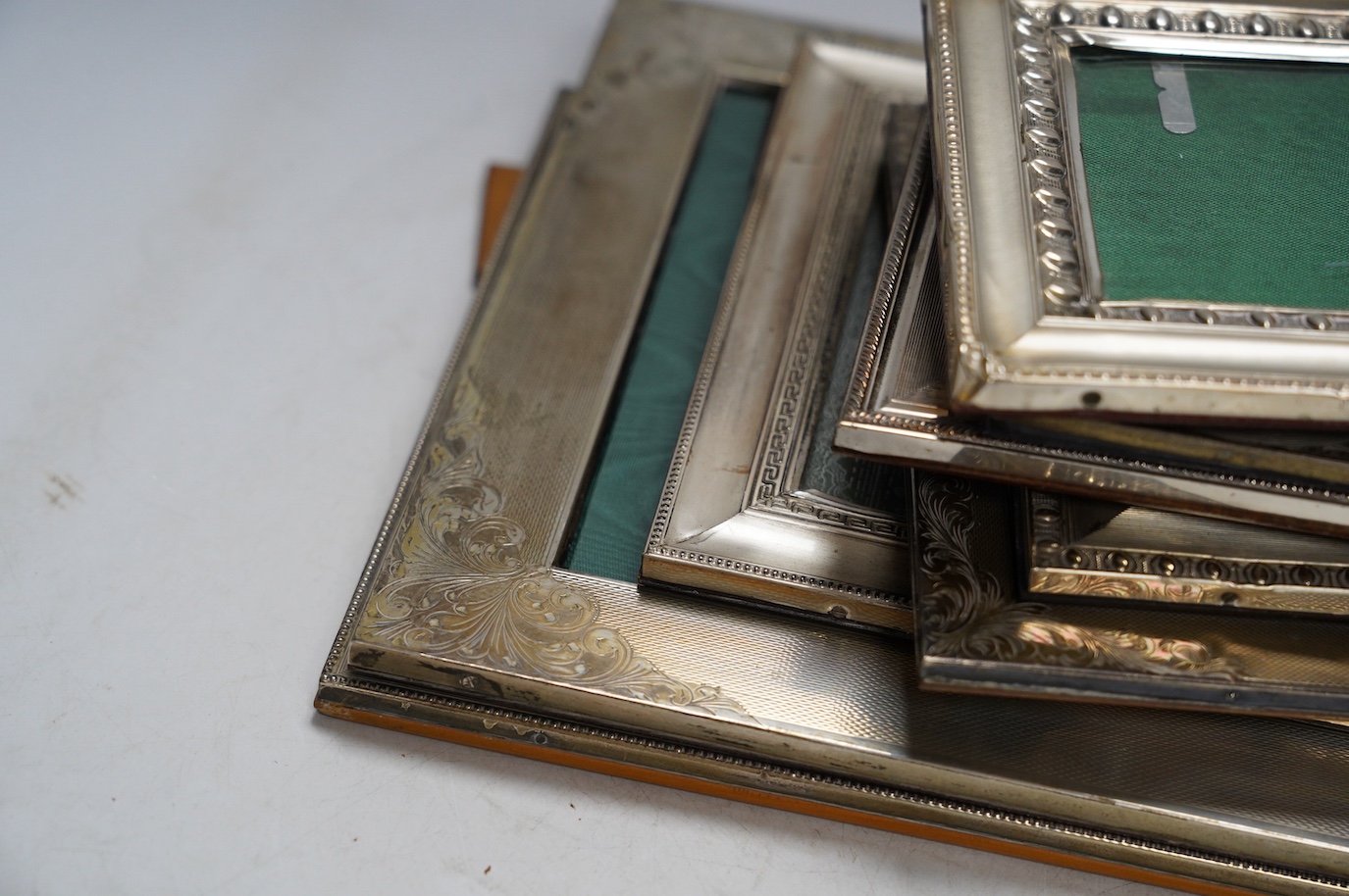 Nine assorted late 20th century 800 standard white metal mounted photograph frames, mainly Italian, including a double frame, largest 29.6cm. Condition - poor to fair